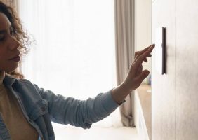 woman looking at thermostat confused